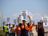 Dockworkers and their supporters hold signs during a strike outside the Bayport Container Terminal in Seabrook, Texas, on October 1, 2024. (