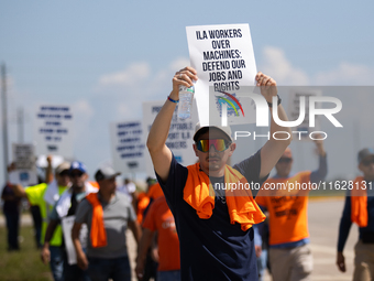 Dockworkers and their supporters hold signs during a strike outside the Bayport Container Terminal in Seabrook, Texas, on October 1, 2024. (