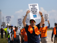 Dockworkers and their supporters hold signs during a strike outside the Bayport Container Terminal in Seabrook, Texas, on October 1, 2024. (