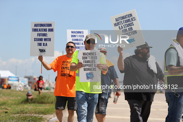 Dockworkers and their supporters hold signs during a strike outside the Bayport Container Terminal in Seabrook, Texas, on October 1, 2024. 