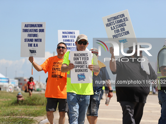 Dockworkers and their supporters hold signs during a strike outside the Bayport Container Terminal in Seabrook, Texas, on October 1, 2024. (