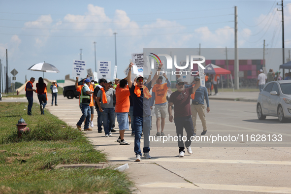 Dockworkers and their supporters hold signs during a strike outside the Bayport Container Terminal in Seabrook, Texas, on October 1, 2024. 