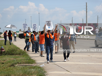 Dockworkers and their supporters hold signs during a strike outside the Bayport Container Terminal in Seabrook, Texas, on October 1, 2024. (