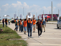 Dockworkers and their supporters hold signs during a strike outside the Bayport Container Terminal in Seabrook, Texas, on October 1, 2024. (