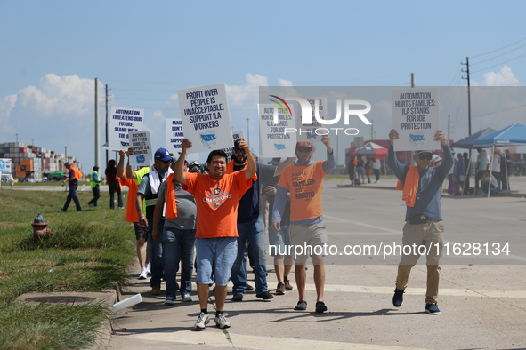 Dockworkers and their supporters hold signs during a strike outside the Bayport Container Terminal in Seabrook, Texas, on October 1, 2024. 