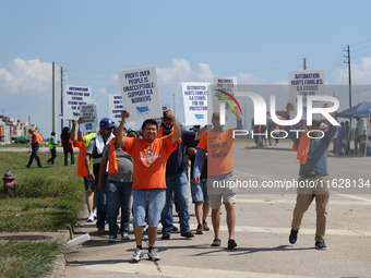 Dockworkers and their supporters hold signs during a strike outside the Bayport Container Terminal in Seabrook, Texas, on October 1, 2024. (