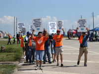 Dockworkers and their supporters hold signs during a strike outside the Bayport Container Terminal in Seabrook, Texas, on October 1, 2024. (