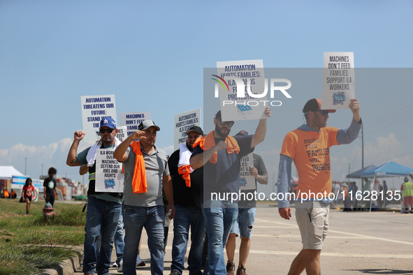 Dockworkers and their supporters hold signs during a strike outside the Bayport Container Terminal in Seabrook, Texas, on October 1, 2024. 