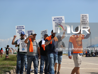 Dockworkers and their supporters hold signs during a strike outside the Bayport Container Terminal in Seabrook, Texas, on October 1, 2024. (