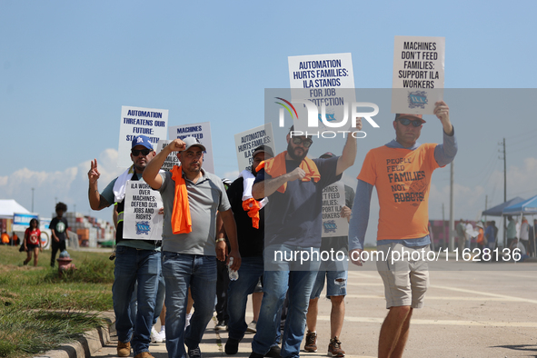 Dockworkers and their supporters hold signs during a strike outside the Bayport Container Terminal in Seabrook, Texas, on October 1, 2024. 