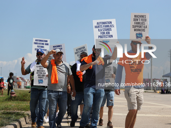 Dockworkers and their supporters hold signs during a strike outside the Bayport Container Terminal in Seabrook, Texas, on October 1, 2024. (