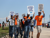 Dockworkers and their supporters hold signs during a strike outside the Bayport Container Terminal in Seabrook, Texas, on October 1, 2024. (