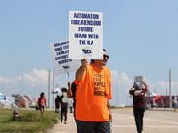 Dockworkers and their supporters hold signs during a strike outside the Bayport Container Terminal in Seabrook, Texas, on October 1, 2024. (