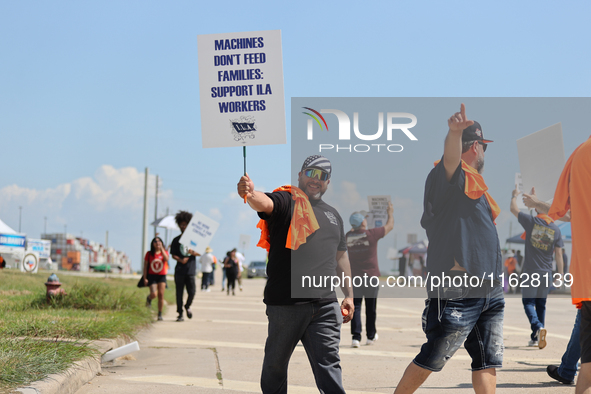 Dockworkers and their supporters hold signs during a strike outside the Bayport Container Terminal in Seabrook, Texas, on October 1, 2024. 