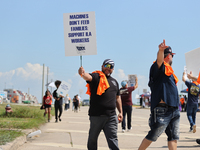 Dockworkers and their supporters hold signs during a strike outside the Bayport Container Terminal in Seabrook, Texas, on October 1, 2024. (