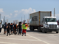 A passing semi-truck honks in a show of support during a dockworker strike outside the Bayport Container Terminal in Seabrook, Texas, on Oct...