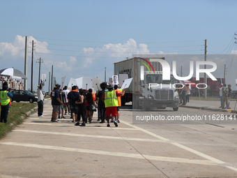 A passing semi-truck honks in a show of support during a dockworker strike outside the Bayport Container Terminal in Seabrook, Texas, on Oct...