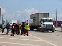 A passing semi-truck honks in a show of support during a dockworker strike outside the Bayport Container Terminal in Seabrook, Texas, on Oct...