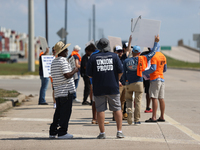 Dockworkers and their supporters hold signs during a strike outside the Bayport Container Terminal in Seabrook, Texas, on October 1, 2024. (