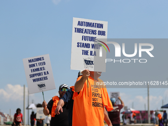 Dockworkers and their supporters hold signs during a strike outside the Bayport Container Terminal in Seabrook, Texas, on October 1, 2024. (