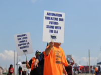 Dockworkers and their supporters hold signs during a strike outside the Bayport Container Terminal in Seabrook, Texas, on October 1, 2024. (