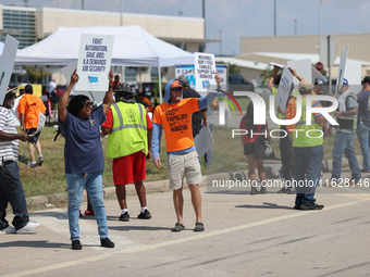 Dockworkers and their supporters hold signs during a strike outside the Bayport Container Terminal in Seabrook, Texas, on October 1, 2024. (