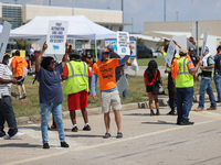 Dockworkers and their supporters hold signs during a strike outside the Bayport Container Terminal in Seabrook, Texas, on October 1, 2024. (