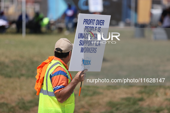 Dockworkers and their supporters hold signs during a strike outside the Bayport Container Terminal in Seabrook, Texas, on October 1, 2024. 