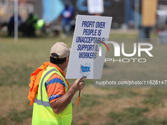 Dockworkers and their supporters hold signs during a strike outside the Bayport Container Terminal in Seabrook, Texas, on October 1, 2024. (