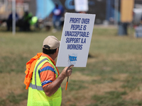 Dockworkers and their supporters hold signs during a strike outside the Bayport Container Terminal in Seabrook, Texas, on October 1, 2024. (