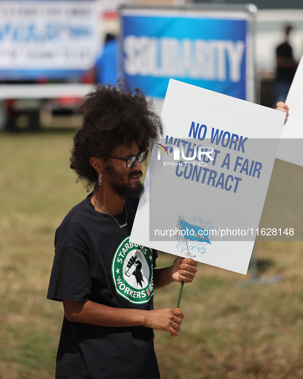 Dockworkers and their supporters hold signs during a strike outside the Bayport Container Terminal in Seabrook, Texas, on October 1, 2024. 