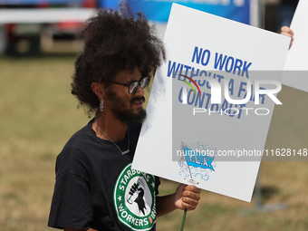 Dockworkers and their supporters hold signs during a strike outside the Bayport Container Terminal in Seabrook, Texas, on October 1, 2024. (