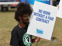 Dockworkers and their supporters hold signs during a strike outside the Bayport Container Terminal in Seabrook, Texas, on October 1, 2024. (