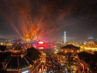 Visitors watch a light show at the West Tour Park in Huai'an City, China, on October 1, 2024. (