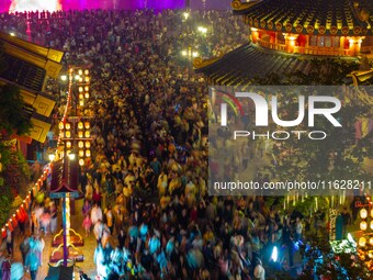 Visitors watch a light show at the West Tour Park in Huai'an City, China, on October 1, 2024. (