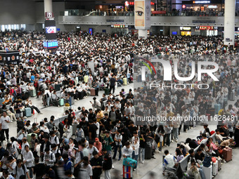 A large number of passengers wait in the waiting room of Nanchang Railway Station in Nanchang, China, on October 1, 2024. (