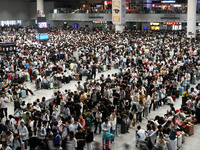 A large number of passengers wait in the waiting room of Nanchang Railway Station in Nanchang, China, on October 1, 2024. (