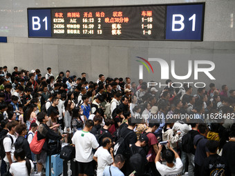 A large number of passengers wait in the waiting room of Nanchang Railway Station in Nanchang, China, on October 1, 2024. (