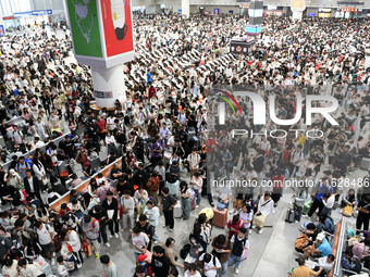 A large number of passengers wait in the waiting room of Nanchang Railway Station in Nanchang, China, on October 1, 2024. (