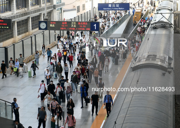 Passengers get off the train at Nanchang Railway Station in Nanchang, China, on October 1, 2024. 