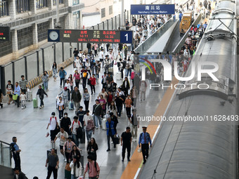 Passengers get off the train at Nanchang Railway Station in Nanchang, China, on October 1, 2024. (