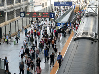 Passengers get off the train at Nanchang Railway Station in Nanchang, China, on October 1, 2024. (