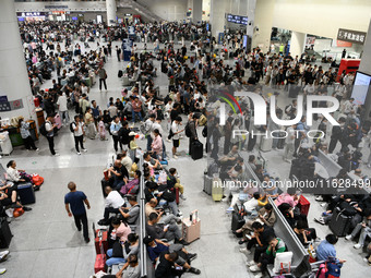 A large number of passengers wait in the waiting room of Nanchang Railway Station in Nanchang, China, on October 1, 2024. (