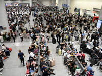 A large number of passengers wait in the waiting room of Nanchang Railway Station in Nanchang, China, on October 1, 2024. (