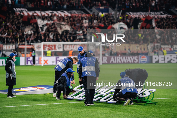 Workers set a Champions League sign prior to the UEFA Champions League 2024/25 League Phase MD2 match between Bayer 04 Leverkusen and AC Mil...