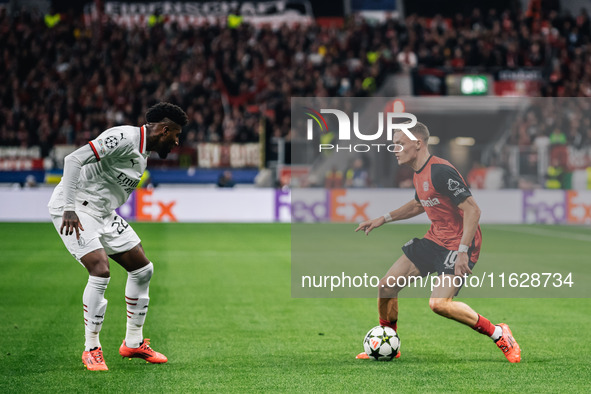 Florian Wirtz of Bayer 04 Leverkusen and Emerson of AC Milan are in action during the UEFA Champions League 2024/25 League Phase MD2 match b...