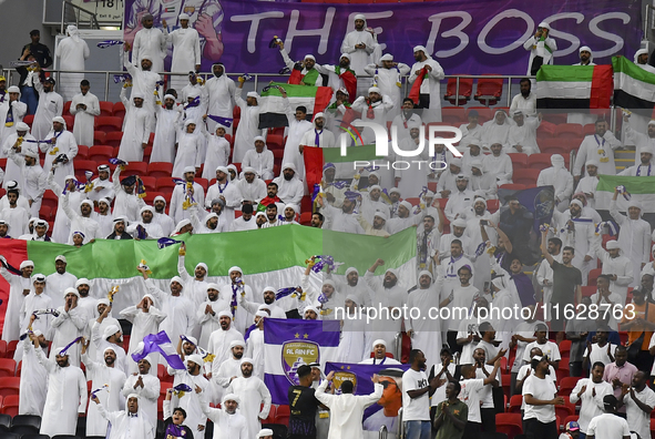 Al Ain FC supporters cheer for their team during the AFC Champions League elite west football match between Qatar's Al Gharafa SC and United...