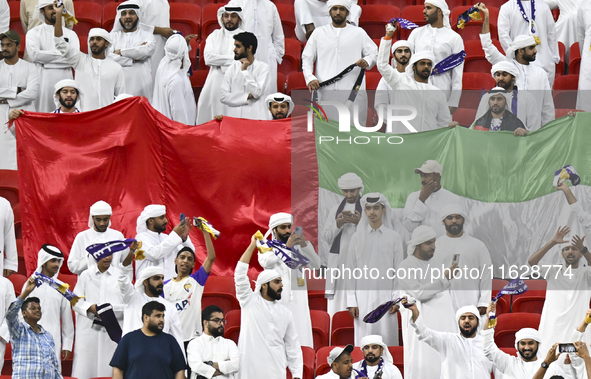 Al Ain FC supporters cheer for their team during the AFC Champions League elite west football match between Qatar's Al Gharafa SC and United...