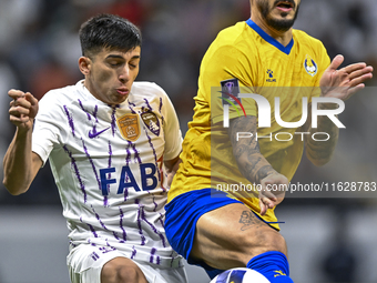 Jose Luis Mato of Al Gharafa SC battles for the ball with Mateo Sanabria of Al Ain FC during the AFC Champions League elite west football ma...