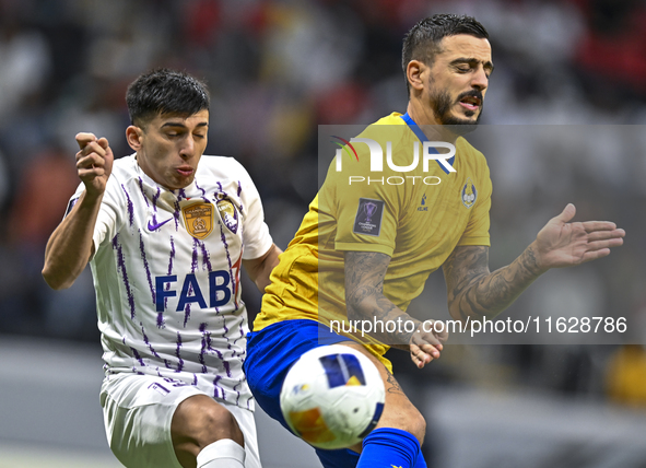 Jose Luis Mato of Al Gharafa SC battles for the ball with Mateo Sanabria of Al Ain FC during the AFC Champions League elite west football ma...